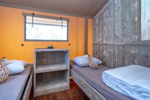 a bedroom with two bunk beds and a window at Marinaparcs Almere in Almere