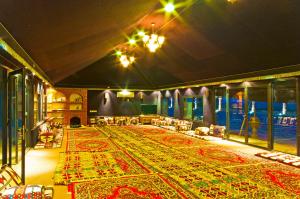 a large room with a large rug on the floor at Al Malfa Resort in Unayzah