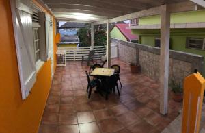 a balcony with a table and chairs on a building at Appt La Rose du Désert in Terre-de-Haut