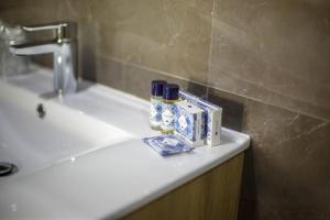 a bathroom sink with toiletries on top of it at Hotel Fafense in Fafe +45 photos