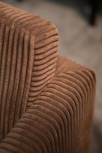 a close up of the arm of a brown couch at Hotel The Neufchatel in Brussels