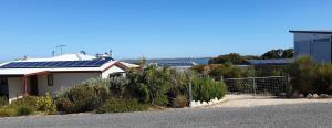 a house with solar panels on the side of the road at Samphire: Coorong Accommodation in Meningie