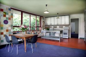 a kitchen with a wooden table and chairs at Huge stylish three bedroom apartment with pool in Melbourne