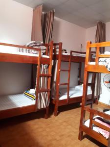 a room with three bunk beds and a ladder at Linh Homestay and motorbikes rent in Ha Giang
