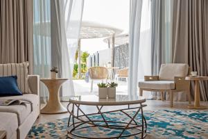 a living room filled with furniture and a table at Jumeirah at Saadiyat Island Resort in Abu Dhabi