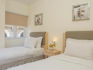 Кровать или кровати в номере d'primahotel WTC Mangga Dua