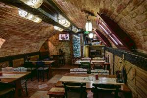 a restaurant with tables and chairs in a room at Vila Hit in Ruma