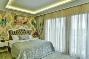 a bedroom with a bed and a large window at Bon Hotel Old City in Istanbul