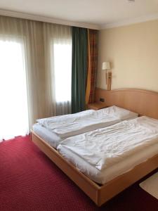 Postel nebo postele na pokoji v ubytování Hotel Pflieger