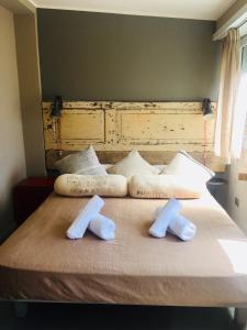 a bed with two white towels on top of it at Terrazza Munira Trastevere in Rome