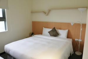 Rúm í herbergi á Merryday Hotel Banqiao