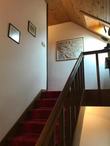a staircase in a house with red stairs at Apartments Janjusevic in Bled