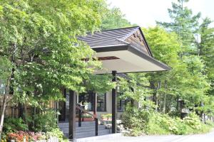 a building with a roof on the side of a street at Yumoto Itaya in Nikko +37 photos
