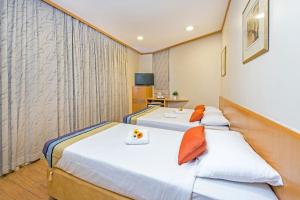 Postel nebo postele na pokoji v ubytování Hotel 81 Sakura