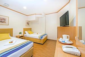 Postel nebo postele na pokoji v ubytování Hotel 81 Sakura