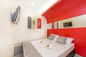 a bedroom with a bed with two plates of food on it at Hotel 81 Rochor in Singapore