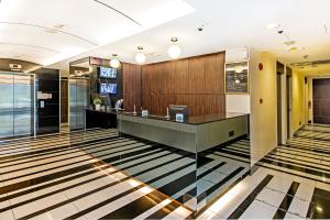 a lobby with a reception desk in a building at Hotel 81 Rochor in Singapore