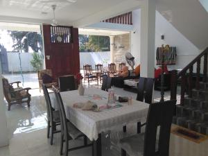 a dining room with a table and chairs at VILLA ARIANNA in Wattala