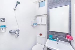 a bathroom with a toilet and a sink and a mirror at Hotel 81 Selegie in Singapore