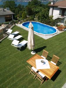 a patio with a table and chairs and a pool at Villa Mimosa in Colico