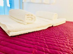 two towels are sitting on top of a bed at Appartement Cap Estivales in Cap d'Agde +6 photos