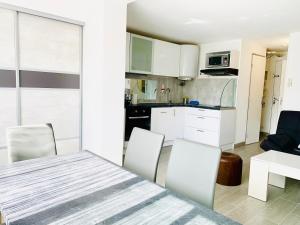 a kitchen and dining room with a table and chairs at Appartement Cap Estivales in Cap d'Agde