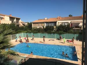 a group of people playing in a swimming pool at Appartement Cap Estivales in Cap d'Agde