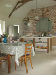 a kitchen with a table and chairs in a room at Job's Mill Cottage in Warminster
