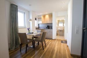a kitchen and dining room with a table and chairs at Hotel Seepark Garni in Überlingen