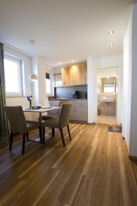 a kitchen and dining room with a table and chairs at Hotel Seepark Garni in Überlingen