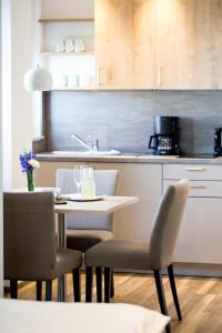 a kitchen with a table and chairs in a kitchen at Hotel Seepark Garni in Überlingen