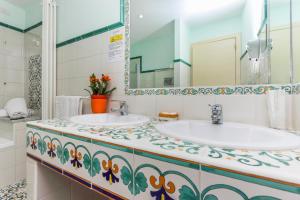 a bathroom with two sinks and a mirror at Hotel Bonadies in Ravello