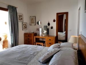 Un dormitorio con una cama, un escritorio y un espejo. en Villa Sellares, en Mojácar 59 fotos más