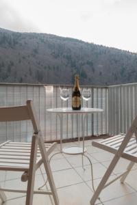 a bottle of wine sitting on a chair in front of a patio at Romantic Jacuzzi Belleview Studio in Sinaia