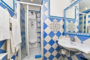 a blue and white bathroom with a sink and a toilet at Hotel Bonadies in Ravello
