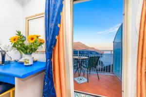 a room with a balcony with a view of the ocean at Hotel Bonadies in Ravello