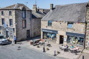 an overhead view of a building with people sitting outside of it at The Stables in Settle