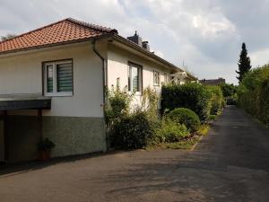 una pequeña casa blanca con entrada en Apartment Messe Köln, en Rösrath