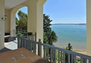 a balcony with a view of the water at Astor House in Torquay