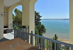 a view from the balcony of a house overlooking the ocean at Astor House in Torquay