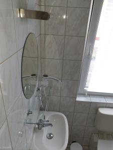 a bathroom with a sink and a mirror at Hotel Sonnenschein in Bad Liebenwerda