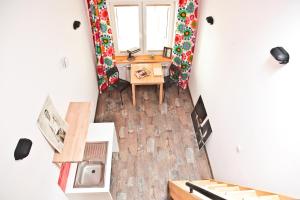 an overhead view of a room with a desk and a window at Szmulson in Warsaw