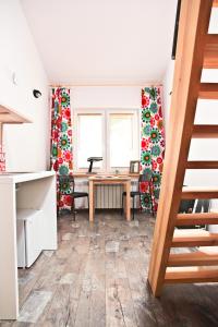 a kitchen with a wooden floor and wooden cabinets at Szmulson in Warsaw