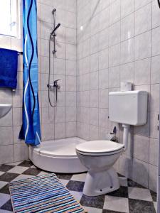 a bathroom with a toilet and a shower at Kiara room in Mokošica