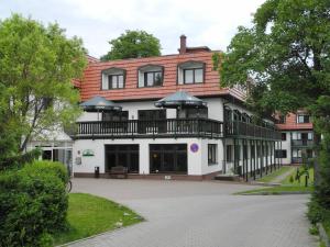 a building with a balcony on top of it at Waldhotel Wandlitz in Wandlitz