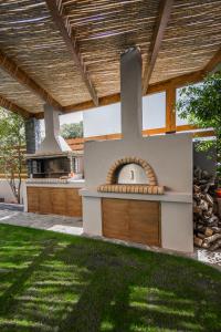 a backyard with a outdoor kitchen and a grill at Lemar Luxury Apartments in Hersonissos