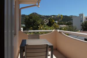 a balcony with a table and chairs on a balcony at Canyamel 27 in Canyamel