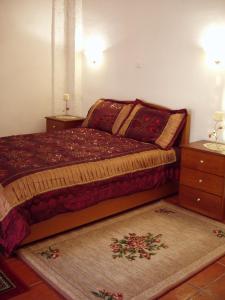 a bedroom with a bed and a dresser and a bed sidx sidx at Elpidas Holiday House in Kardamili