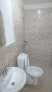 a bathroom with a white toilet and a sink at Kumbaz Pansiyon in Sapanca