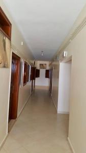 a hallway in a building with a long corridor at HOTEL BEACH CLUB LEGZIRA in Sidi Ifni